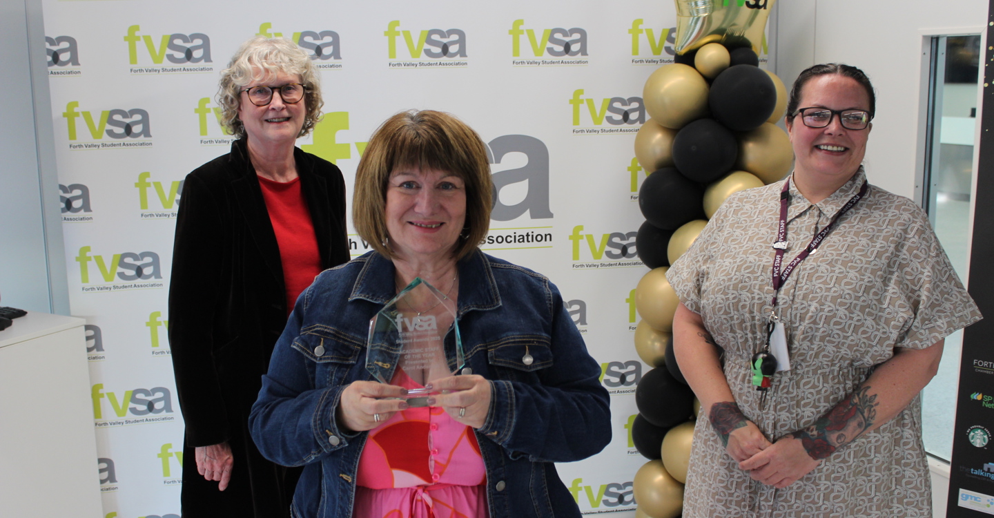 Linda Hughes accepts award on behalf Of Carol Anderson, with Kirsten and Lorna Dougall Vice Chair of the FVC Board of Management